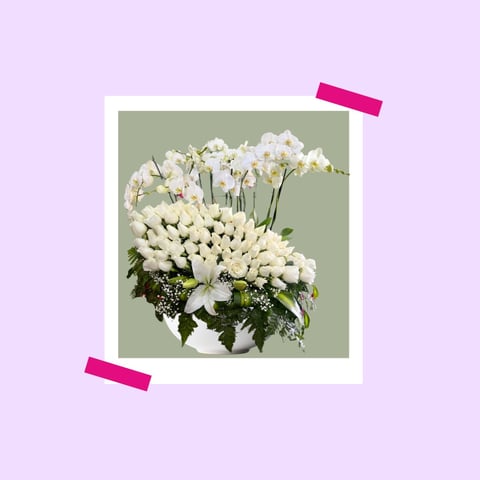 White flowers in vase with green background, mounted on polaroid-style frame with pink tape on lavender background